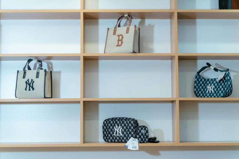 A collection of elegant handbags on wooden shelves, perfect for retail display inspiration.